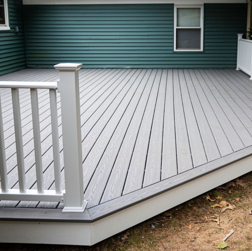 Composite deck with dark green siding
